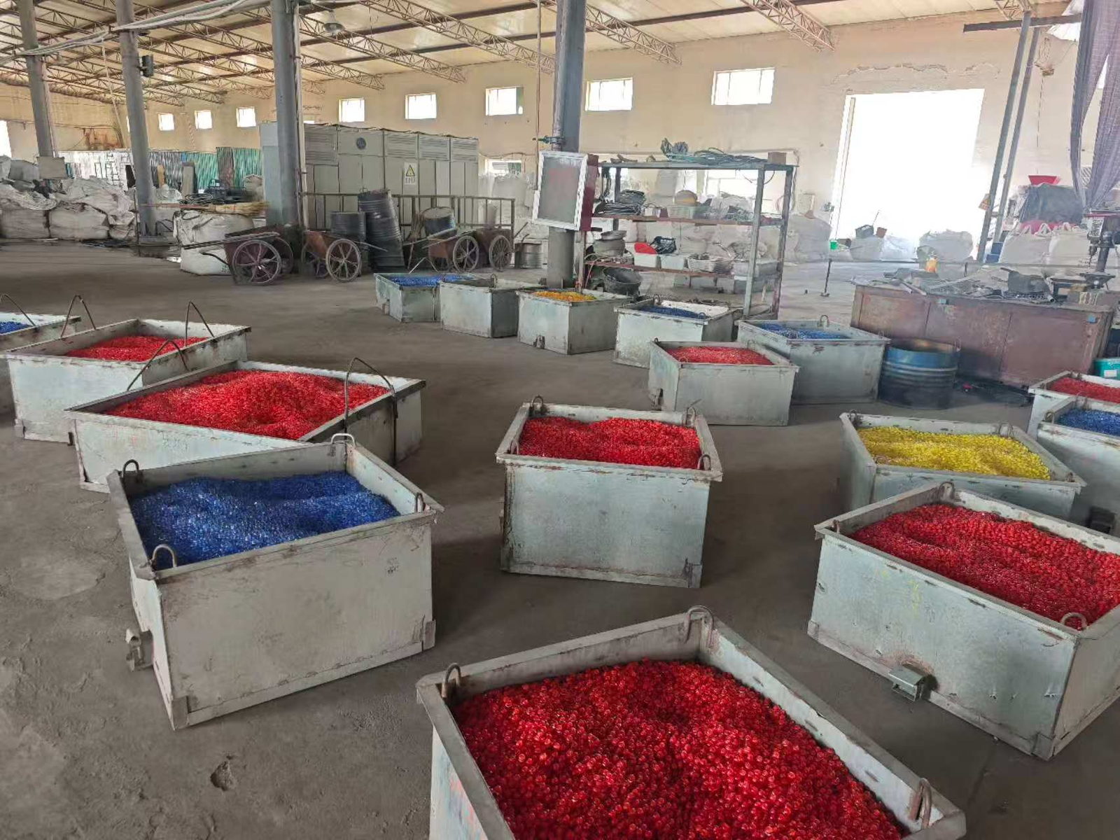 Finished coloured and clear glass beads stored in bulk steel bins at the Jingli plant
